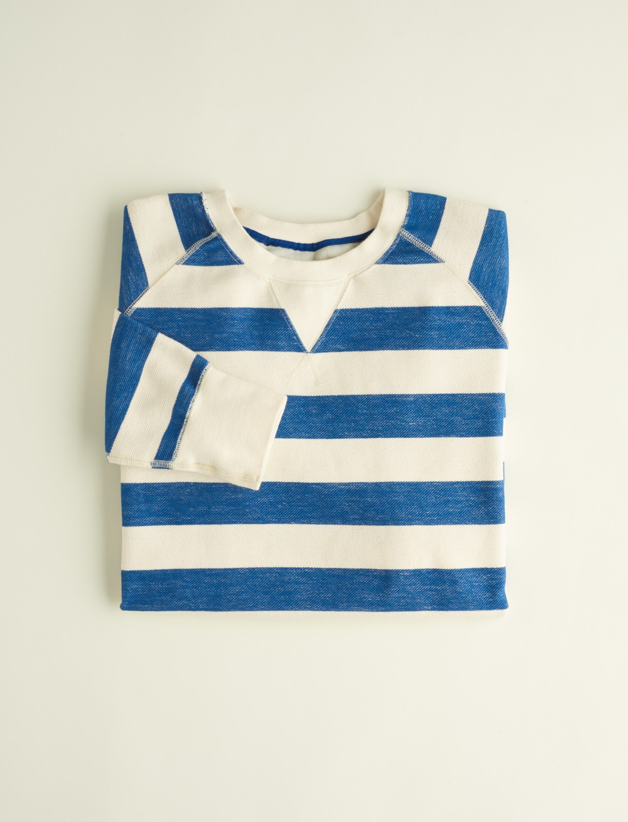 Blue and white striped French Terry sweater by Indigo Robes displayed flat against a light background.