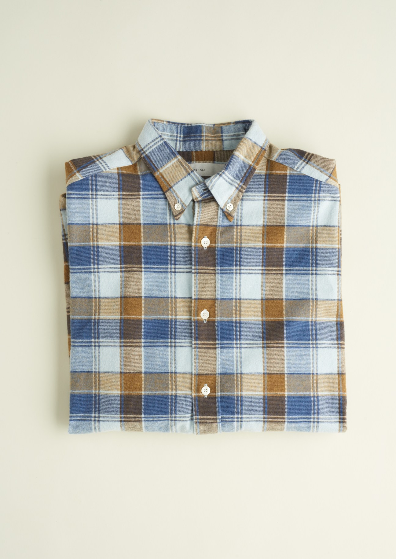 Several checked shirt in brushed cotton with white pearl buttons, laid flat on a neutral background.