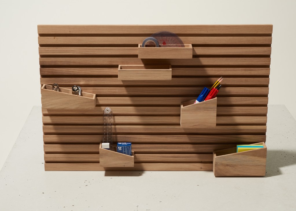 Solid oak desk organizer with eight detachable wooden holders storing pens, cards, and office supplies.