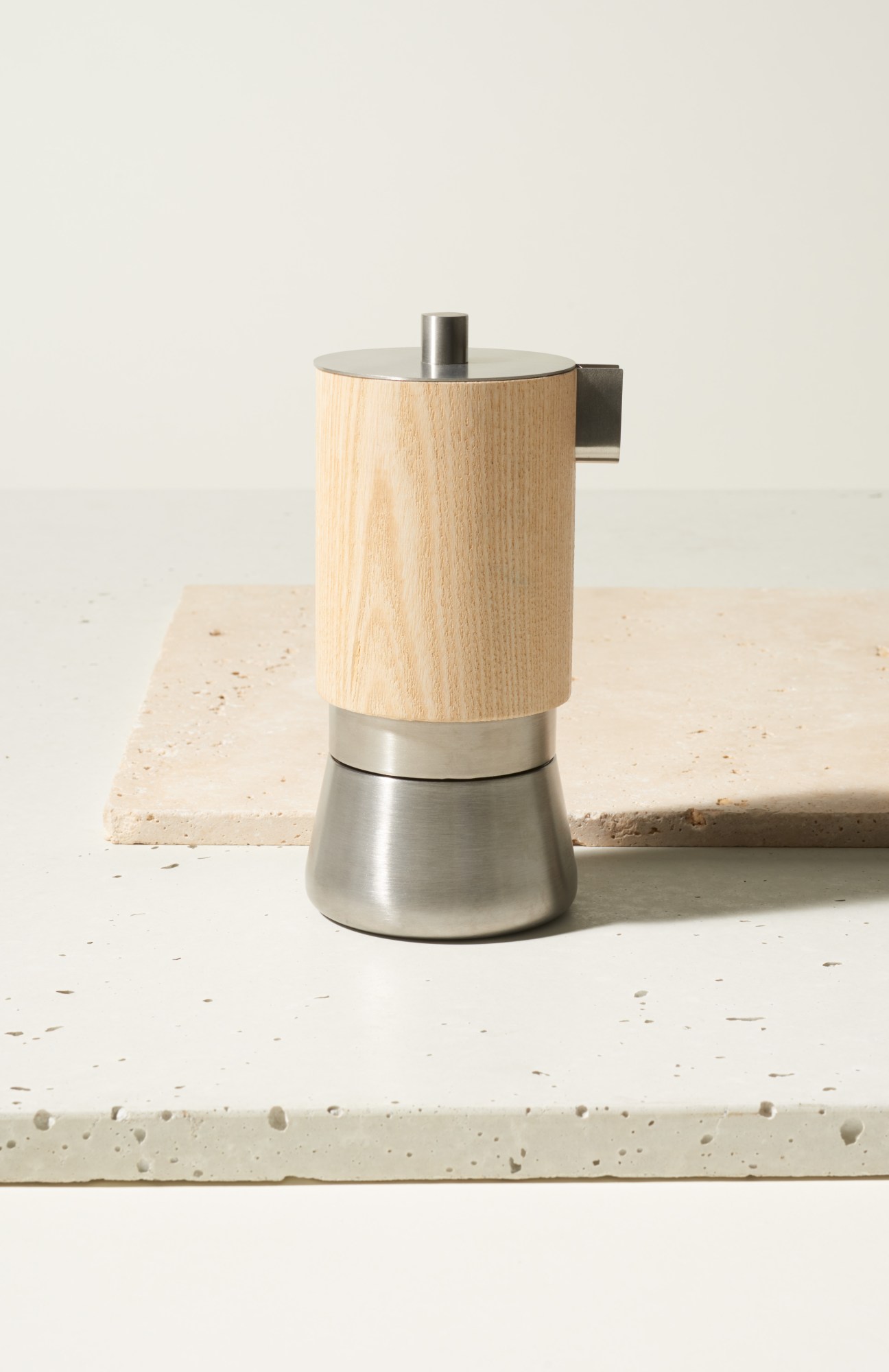 Lunika 360 coffee maker with ash-wood cylindrical body and stainless steel base and top.