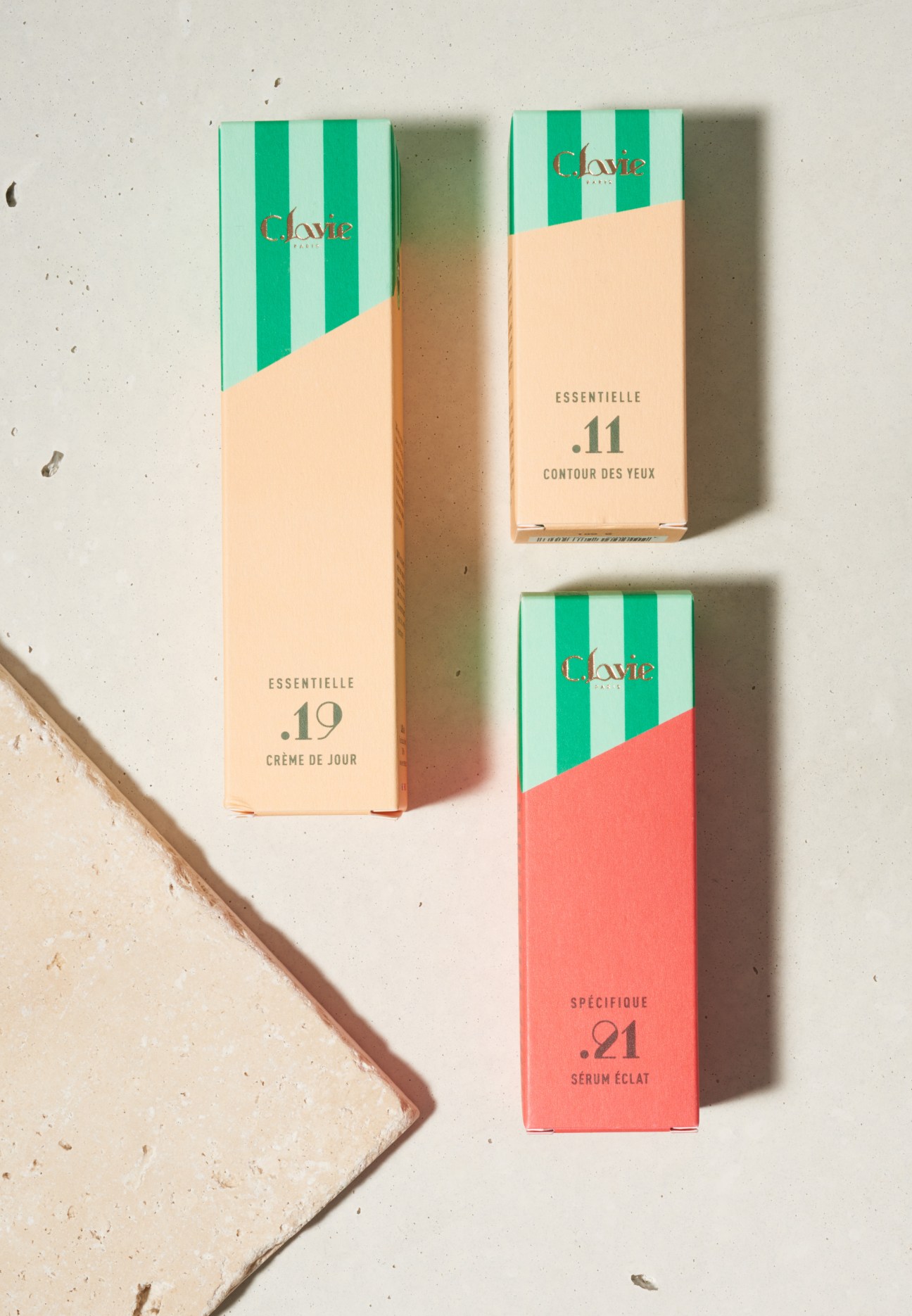 C.Lavie skincare products with striped green and white packaging and peachy labels.