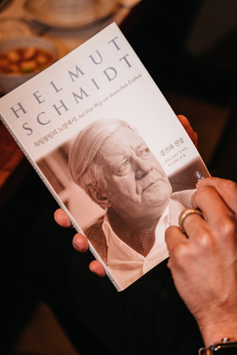 A biography book about Helmut Schmidt held in someone's hands.