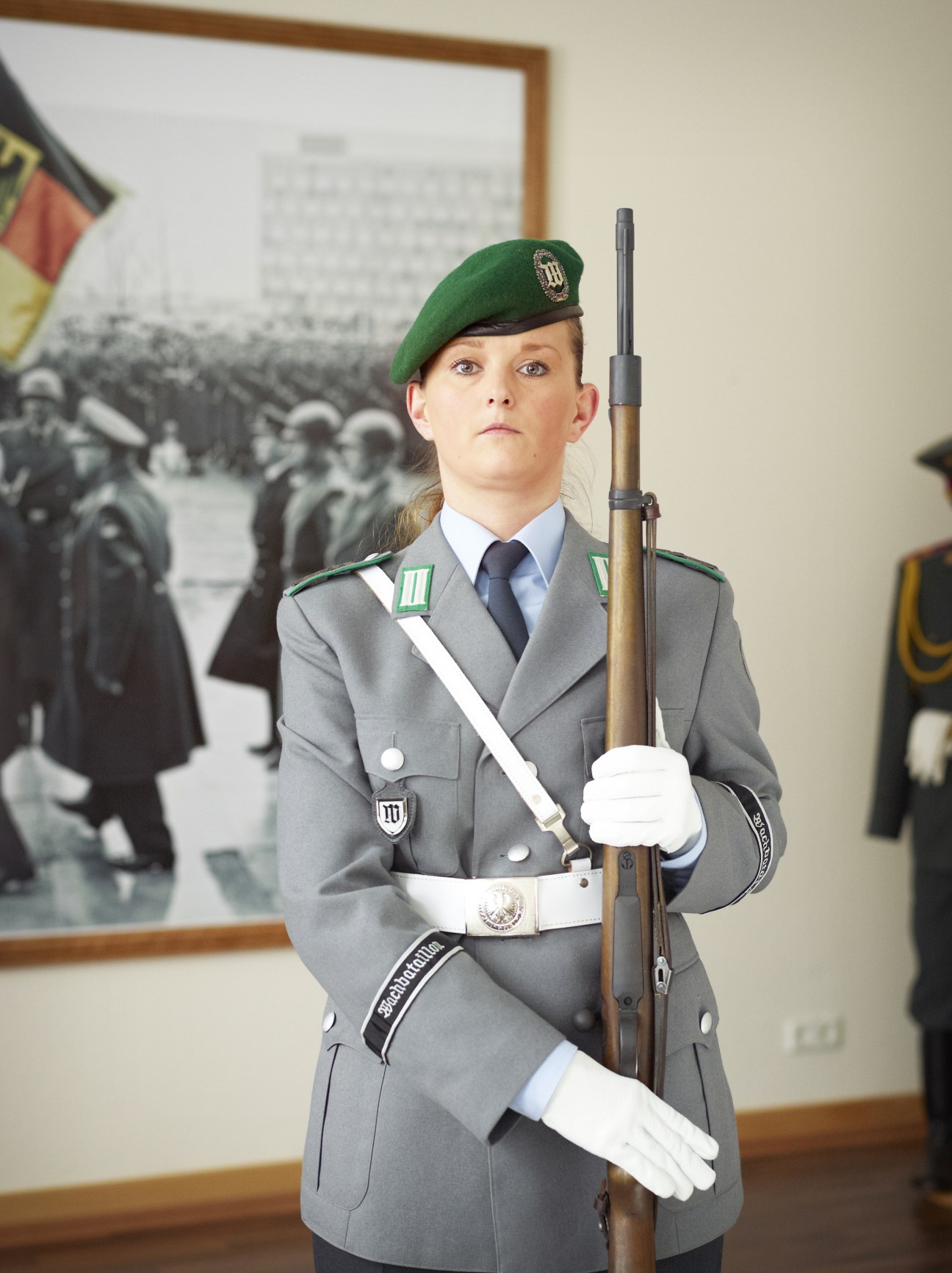 Johanna Pasek in Bundeswehr honour guard uniform with green beret, rifle, and white gloves.