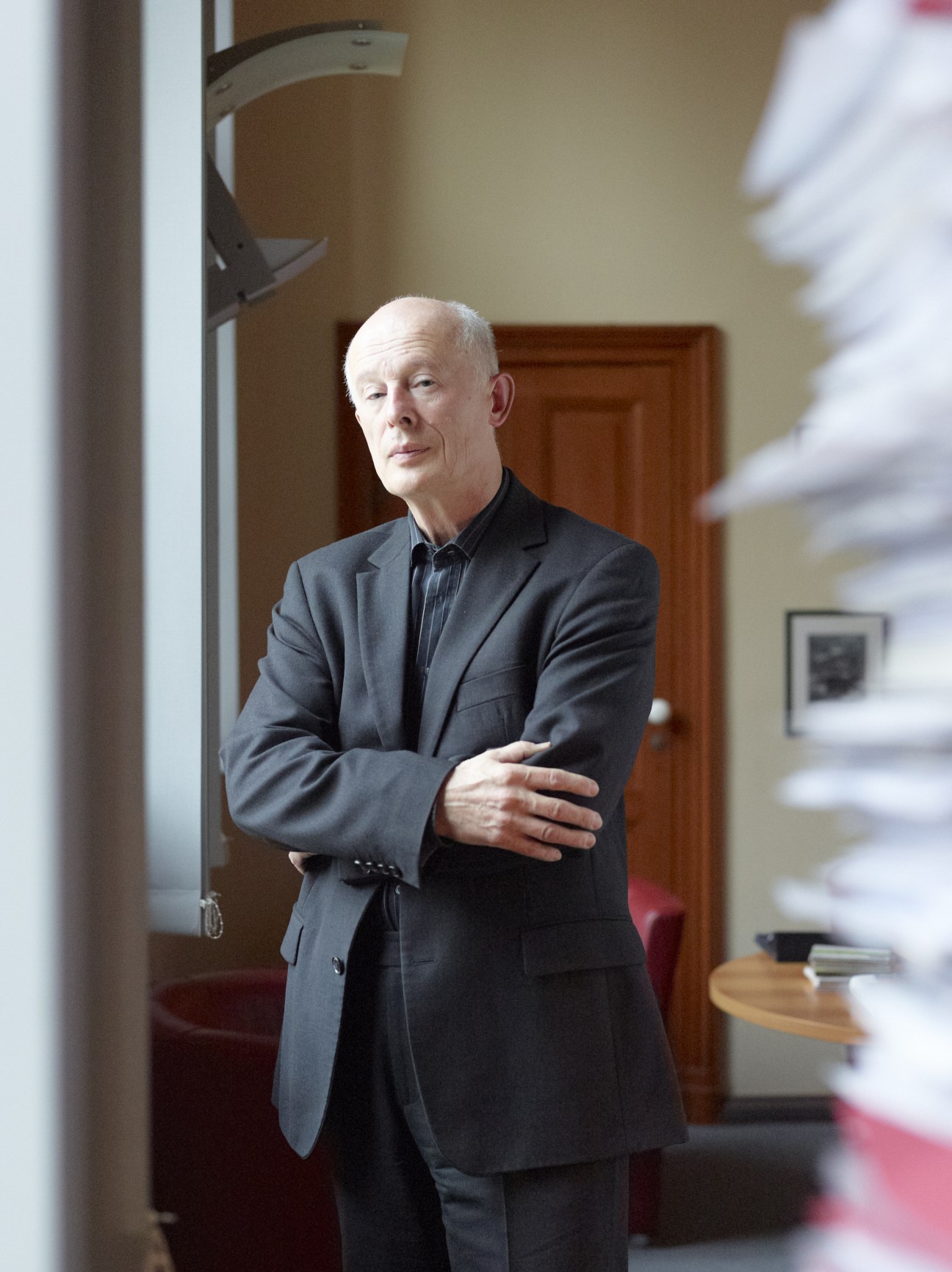 John Schellnhuber, physicist and director of the Potsdam Institute for Climate Impact Research, standing in an interior hallway.