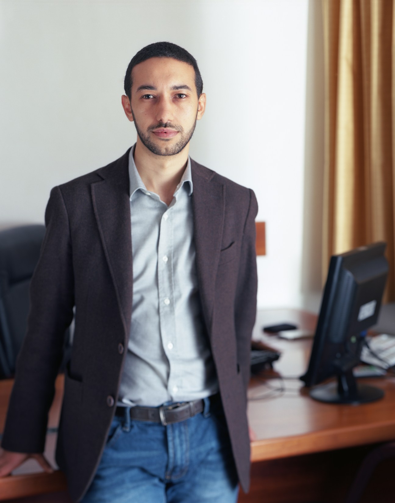 Khalid Chaouki, Italian MP and advocate for asylum seekers, standing in an office.