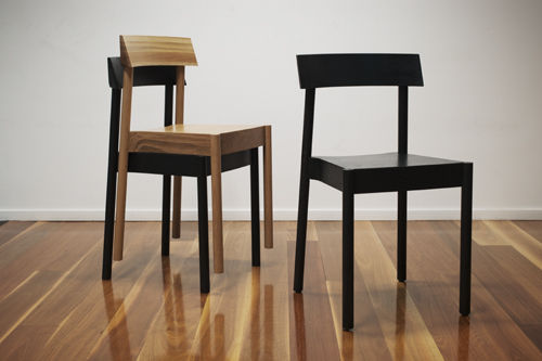 Two wooden chairs in light and dark finishes displayed on wooden flooring.