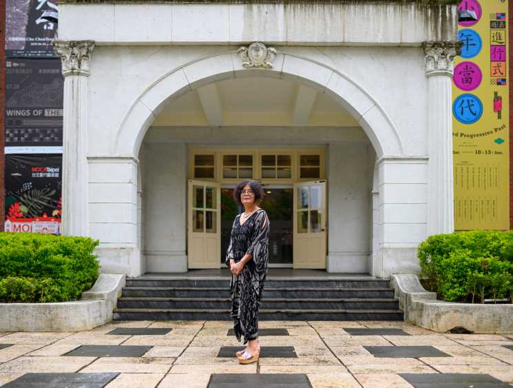 Yuki Pan, director of Museum of Contemporary Art Taipei, standing outside the museum's neoclassical entrance