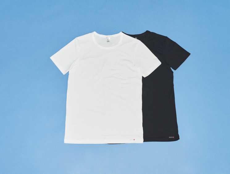 White and black t-shirts displayed on a blue background