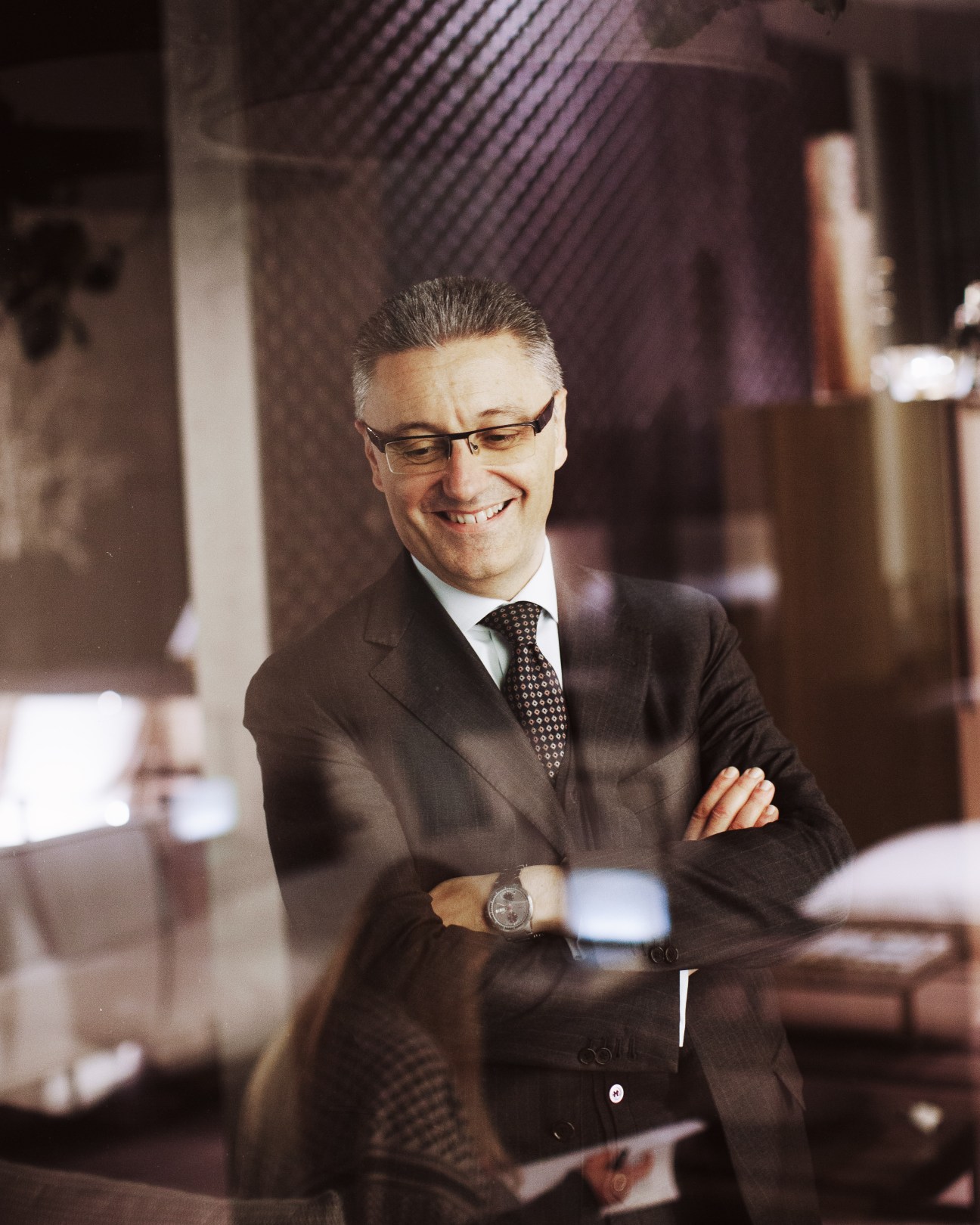 Giovanni del Vecchio, CEO of Giorgetti, smiles with arms crossed at IMM Cologne furniture fair.