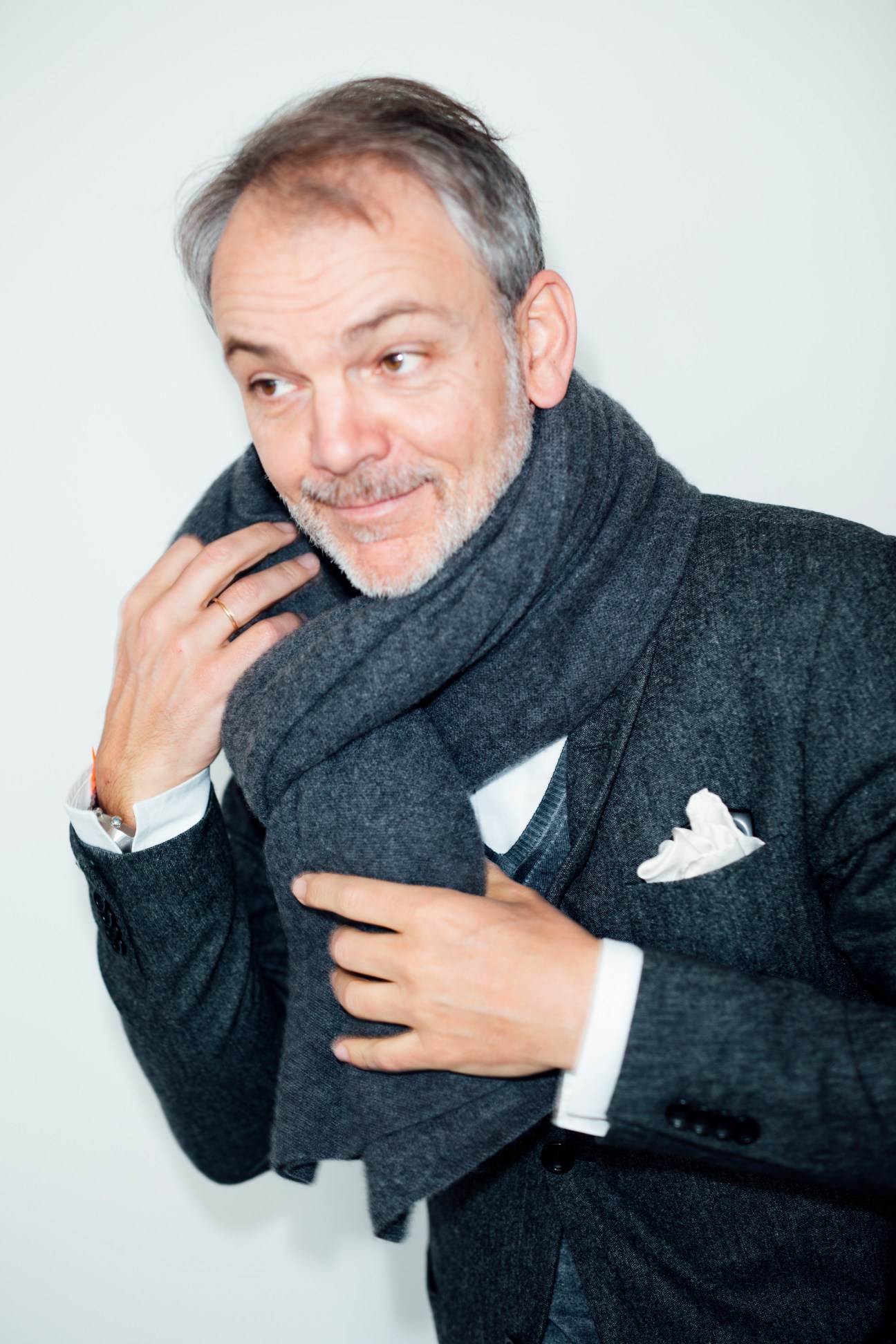 Adrian van Hooydonk, head of design for BMW Group, wearing a dark grey wool scarf and open-collar shirt.