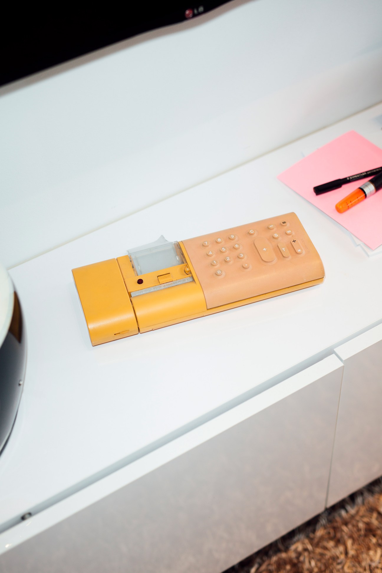 A 1970s yellow and beige calculator by Mario Bellini for Olivetti with integrated rubber membrane keys.