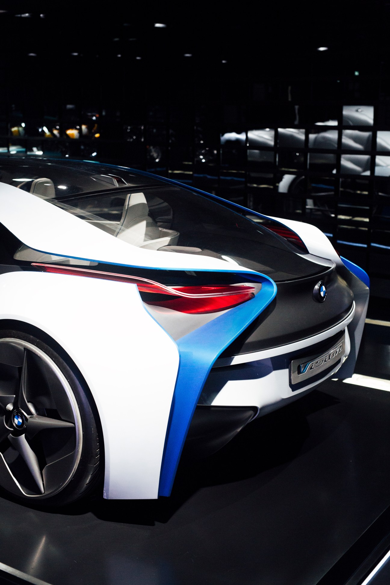 BMW i8 plug-in hybrid electric vehicle with white and blue color scheme displayed at automotive showroom