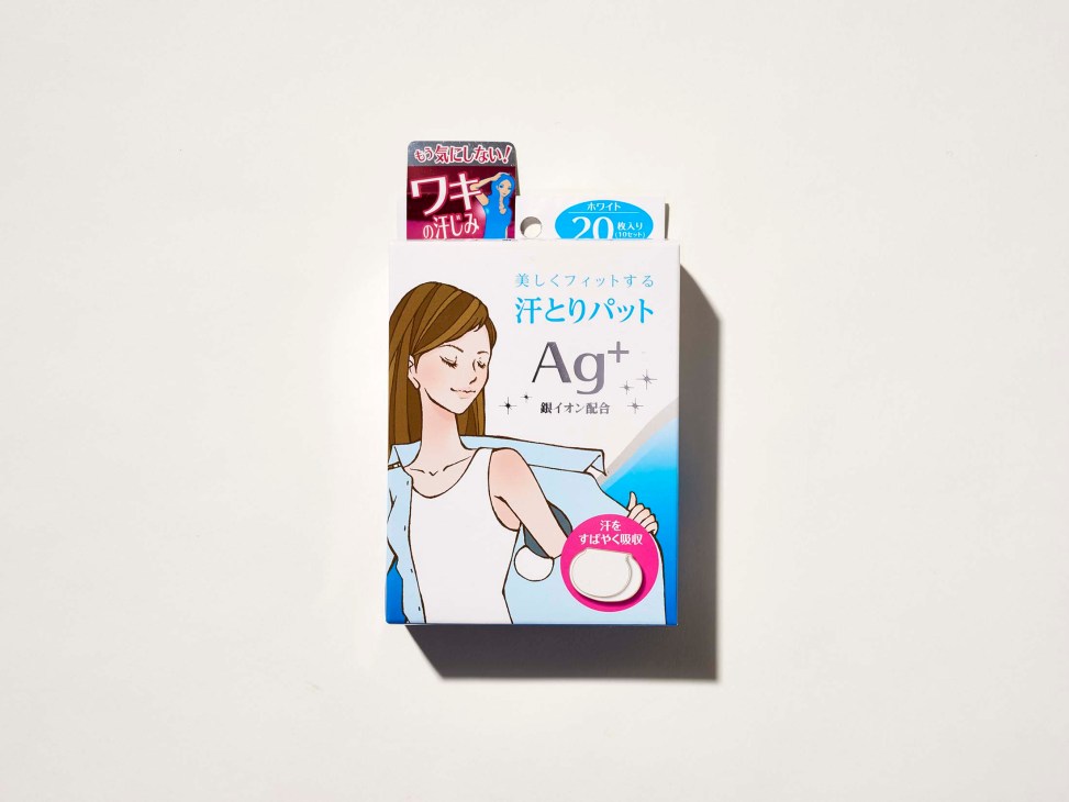 Packaging for Japanese sweat-absorbing underarm pads with silver ion formula and illustrated woman on white background.