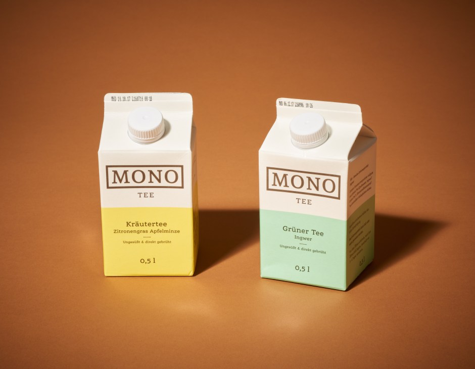 Two Mono Tee ready-to-drink herbal tea cartons with yellow and green labels on a brown background.