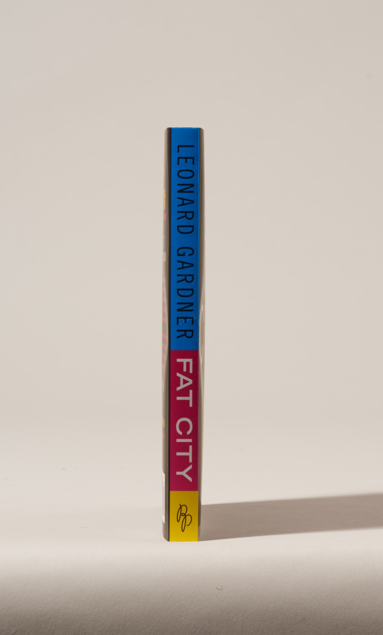 Book spine of Fat City by Leonard Gardner with blue, red, and yellow color blocks