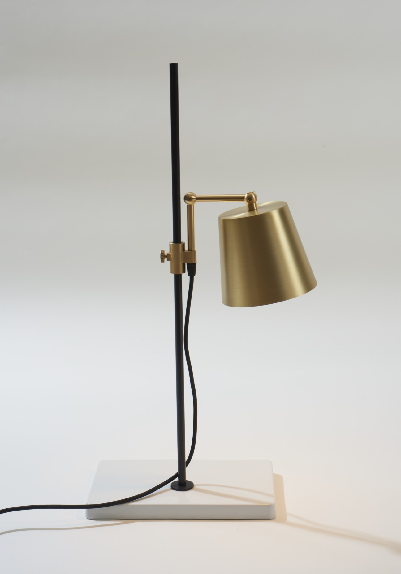 Anatomy Design Lab Light desk lamp with porcelain base, rotating brass arm and shade.