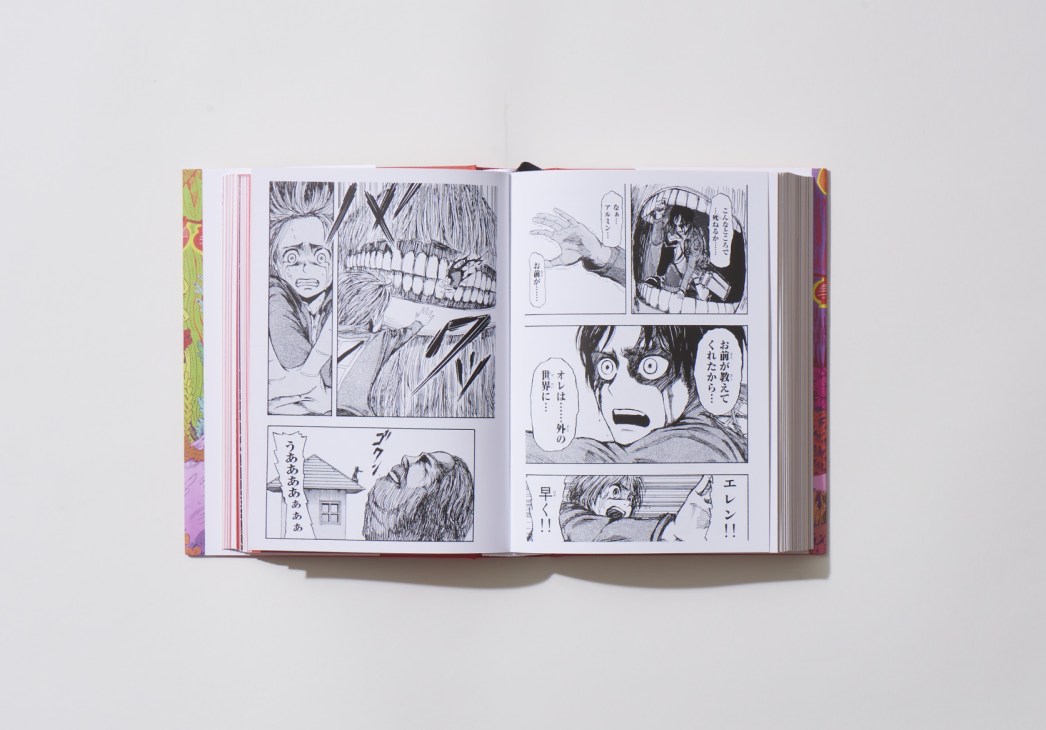 Open book showing manga pages with black and white illustrated panels and Japanese text.