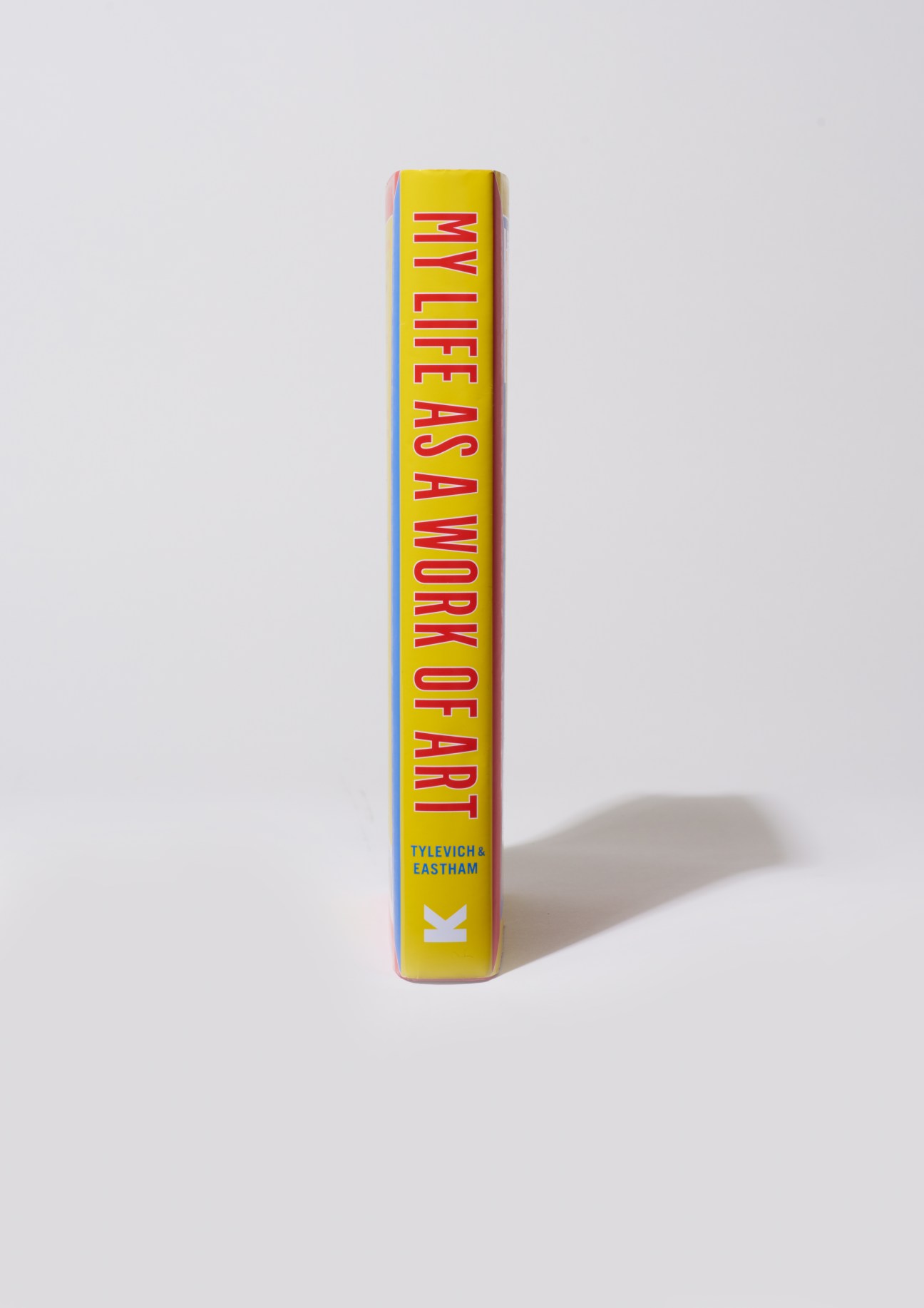 Yellow book spine with red text reading 'My Life as a Work of Art' by Tylevich & Eastham with Laurence King publisher mark