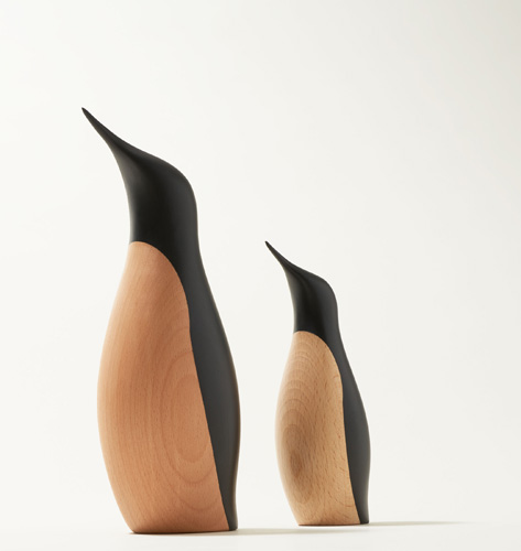 Two wooden penguin sculptures in different sizes with natural beech wood bodies and black hand-painted backs.
