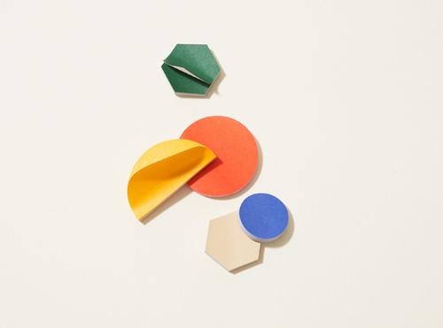 Colorful sticky notes in various shapes including hexagon, circle, and curved forms in green, yellow, coral, and blue.