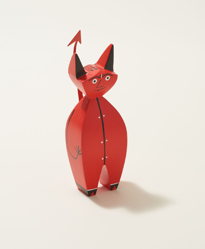Red wooden devil figurine with horns and tail designed by Alexander Girard for Vitra.