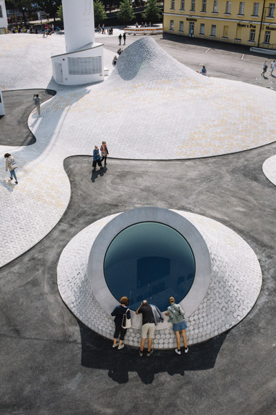 Aerial view of Amos Rex museum in Helsinki with white concrete structures protruding from Lasipalatsi Square.