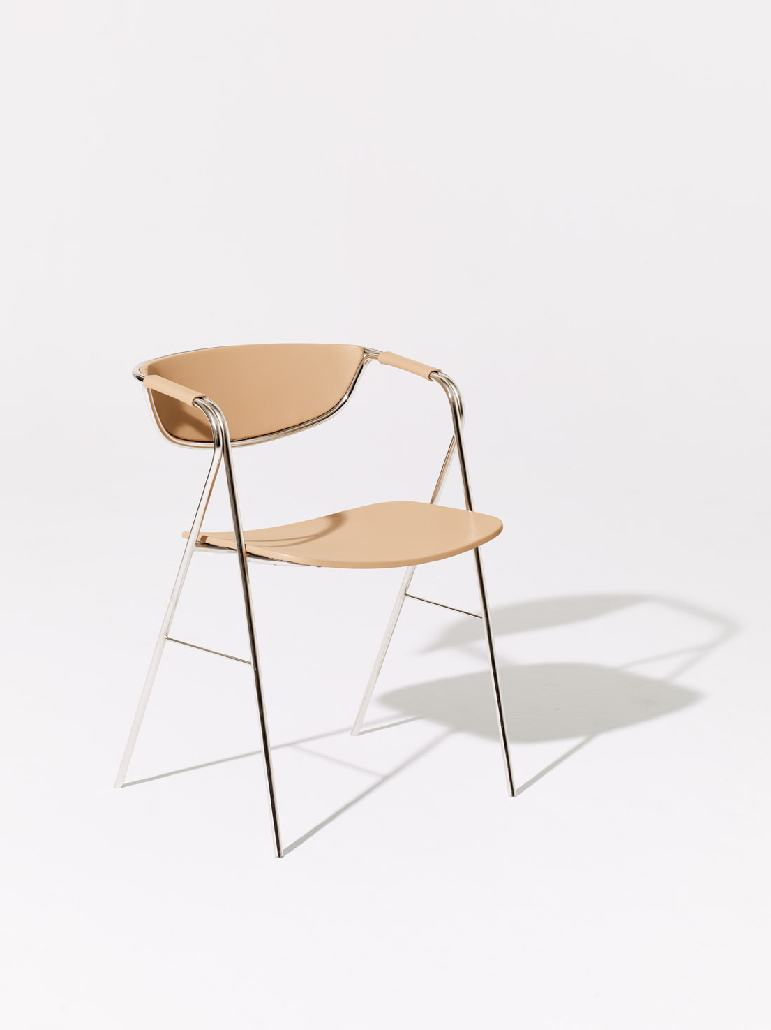 Mete Cane chair with curved chrome frame and beige leather seat and backrest