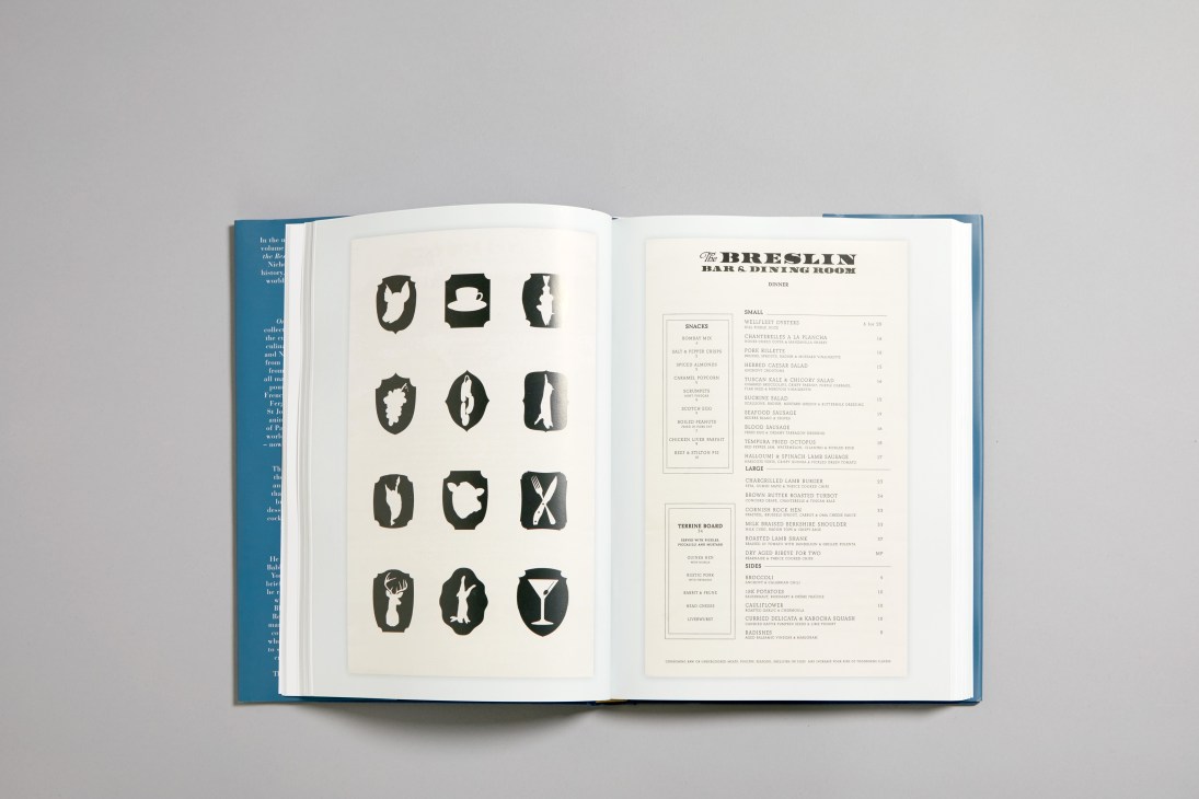 Open book showing vintage menu designs including illustrated food icons and The Breslin Bar & Dining Room dinner menu.