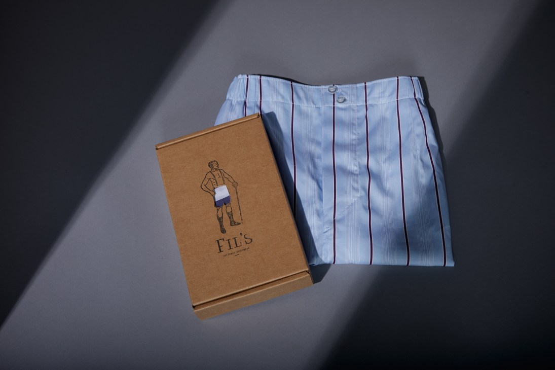 Fil's Underwear boxers with blue striped pattern next to branded recycled cardboard packaging