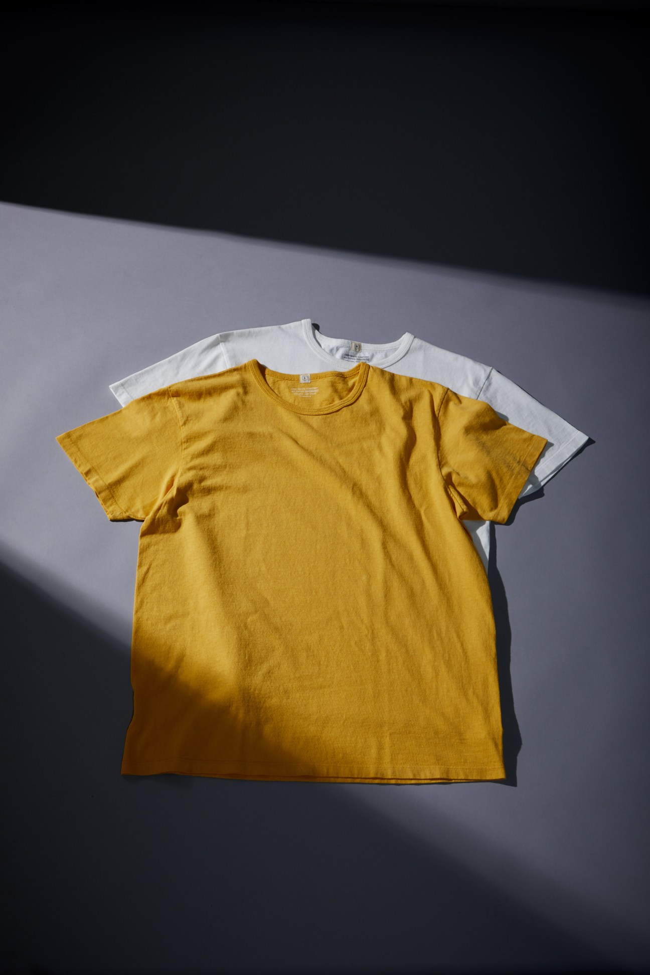 Yellow and white T-shirts displaying quality construction and vintage-inspired design