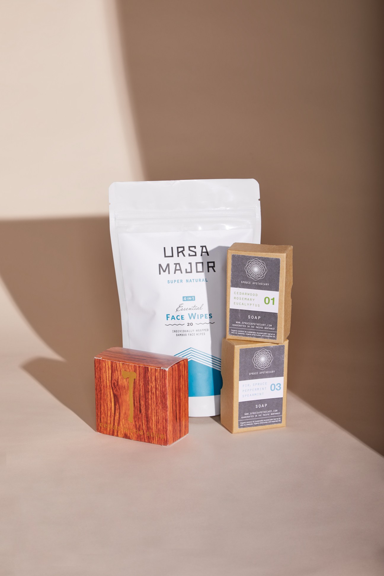 Ursa Major face wipes, Spruce Apothecary soaps, and Kalastyle cedarwood soap displayed together