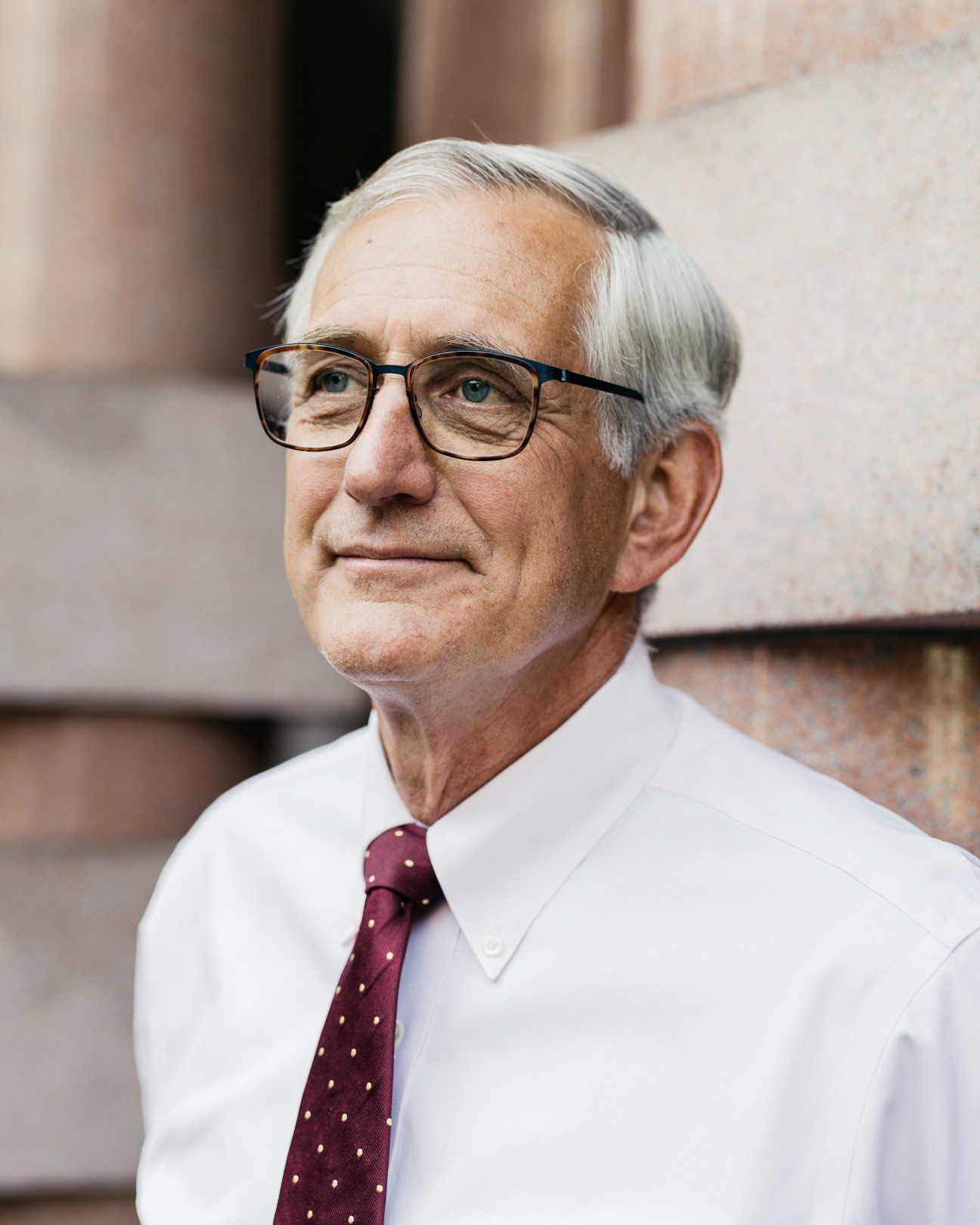 Portrait of Charlie Hales, Mayor of Portland, Oregon, wearing glasses and a burgundy tie.
