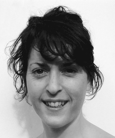 Black and white portrait photograph of a woman with dark hair smiling at the camera