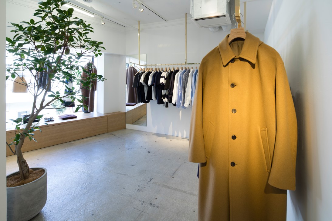 Need Supply Co Tokyo store interior with yellow coat on display and clothing racks