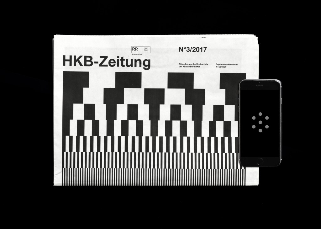HKB-Zeitung magazine cover with pixelated black and white graphic design next to a smartphone displaying augmented reality interface.