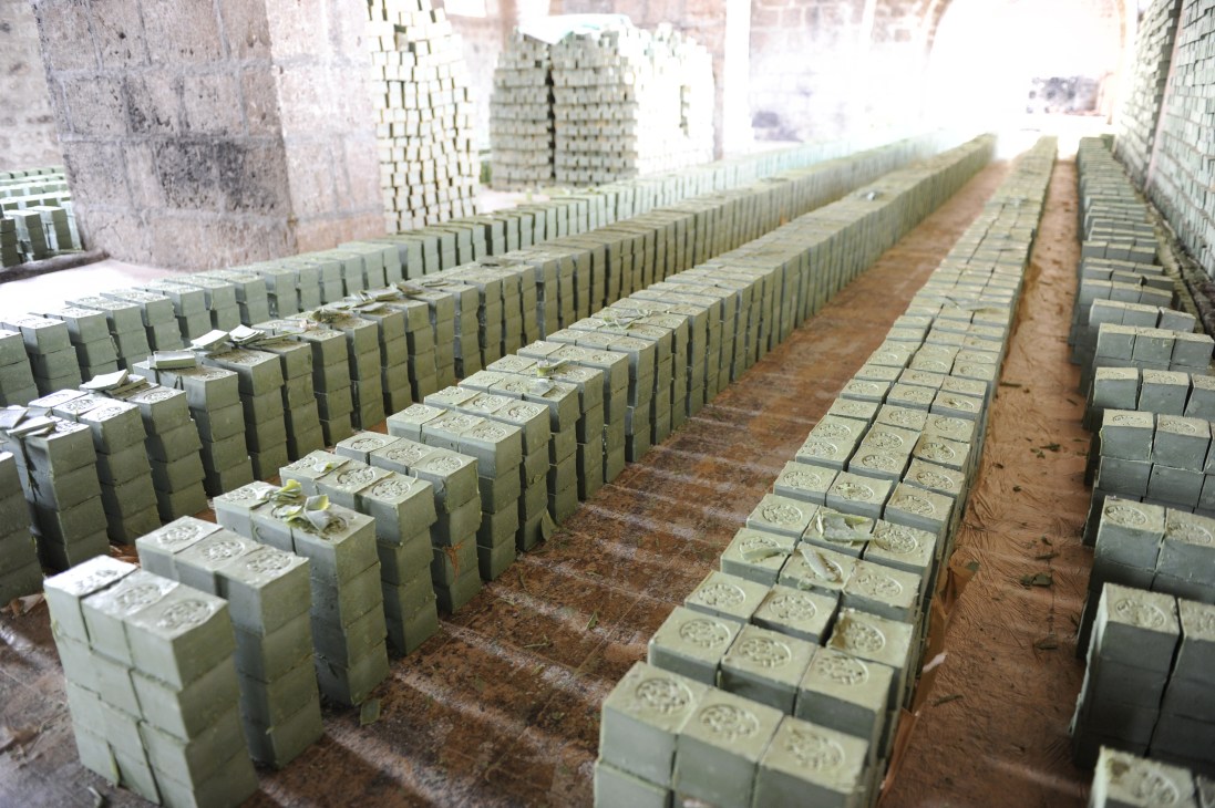 Rows of stacked concrete building blocks arranged in a factory or storage facility.