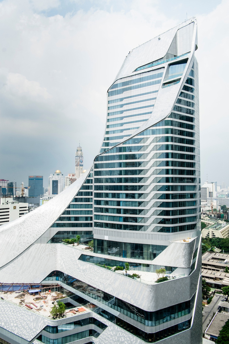 Park Hyatt Bangkok's curved aluminum structure with stupa-inspired design rising above the city skyline.