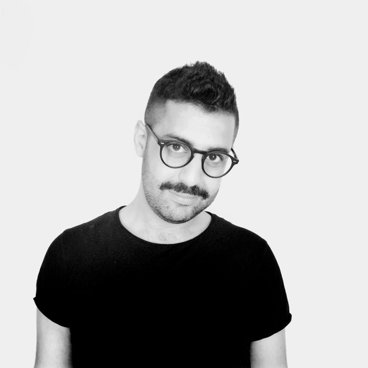 Portrait of Kristyan Sarkis, co-founder of TPTQ Arabic, wearing glasses and a black t-shirt.