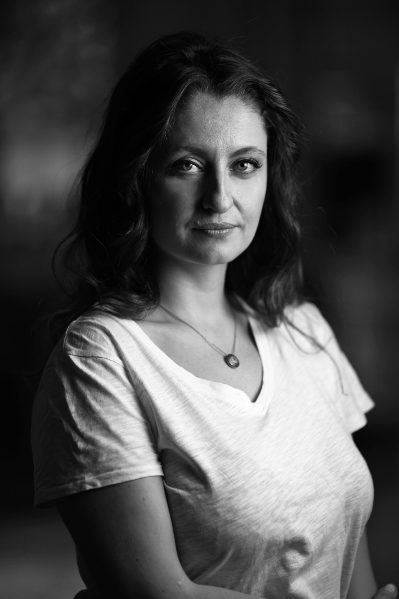 Black and white portrait of Safak Pavey, Turkey's first disabled female MP, wearing a white top.