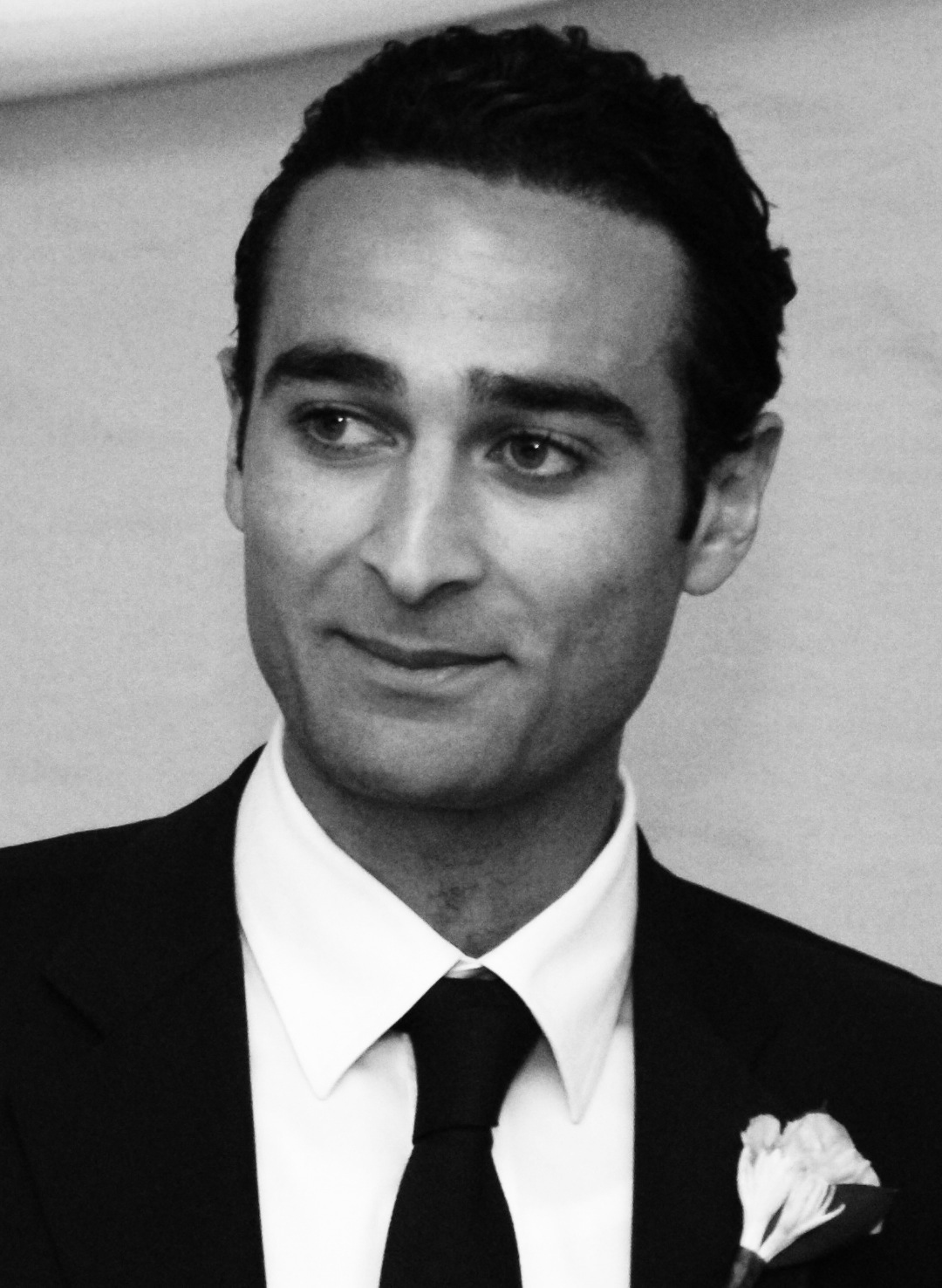 Black and white portrait photograph of a man in formal business attire with suit and tie.