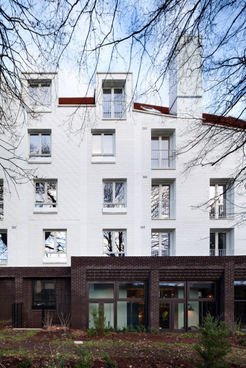 Park House retirement community in Harpenden showing white facade with red gabled roofs and brick ground floor