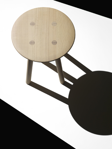 Foster + Partners' Ovo timber stool by Benchmark with light wood seat and angular legs.