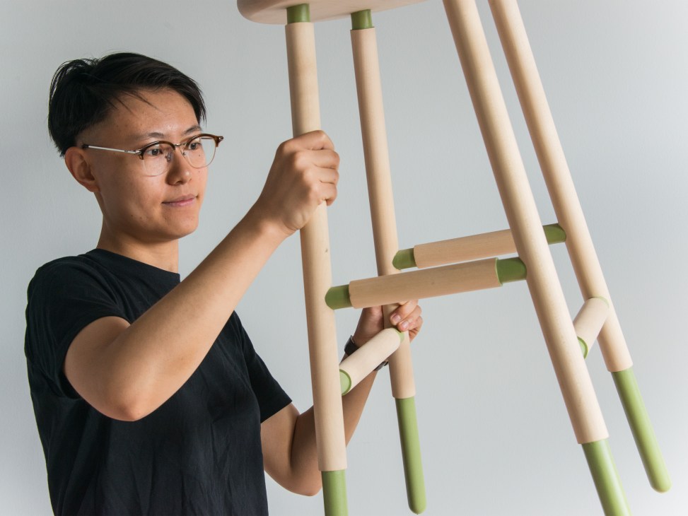 Bowen Liu demonstrates her bentwood furniture design with wooden stool components featuring natural wood and green accents