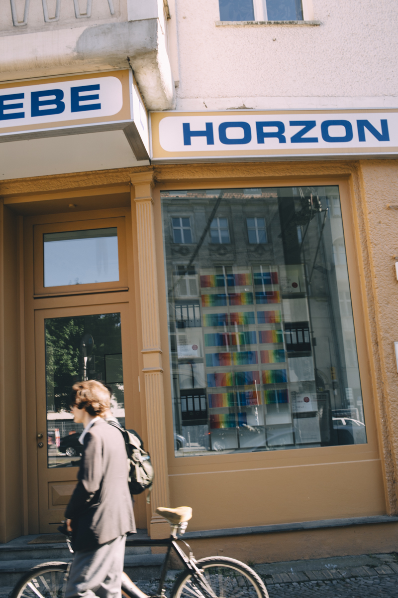 Woman walking past Moebel Horzon furniture shop storefront in Berlin