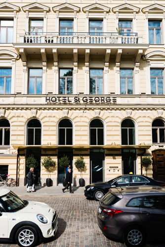 Hotel St George facade in Helsinki with classical architecture and storefront entrance.