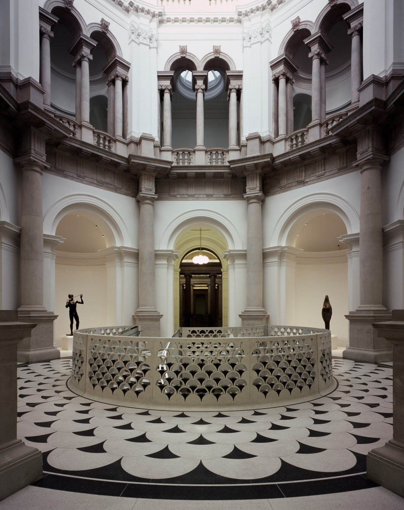 Tate Britain's rotunda with a spiral staircase featuring a perforated metal design, designed by Caruso St John Architects.