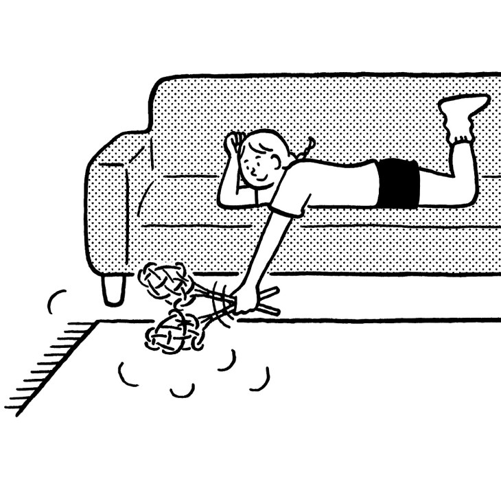 Line illustration of a person relaxing on a couch with tangled yarn balls on the floor below.
