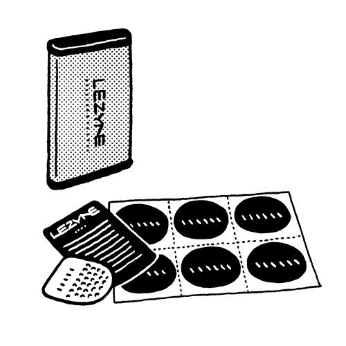Illustration of Lezyne repair kit showing aluminium container with glueless patches and stainless-steel tube scuffer.