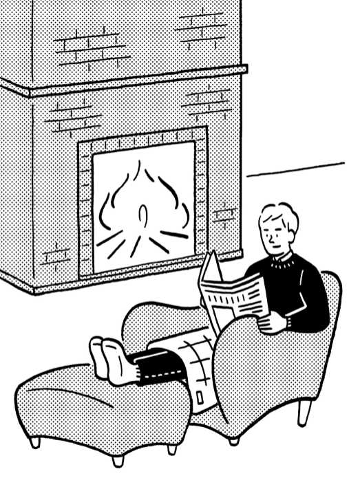 Person sitting in armchair by fireplace, reading newspaper, wrapped in red and black checked wool blanket.