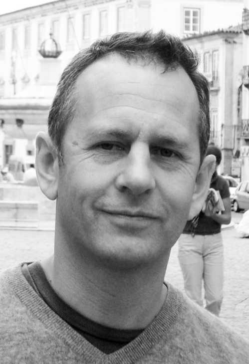 Black and white portrait of Arnaud Montigny, principal of MCH Arnaud Montigny design studio, in an urban setting.